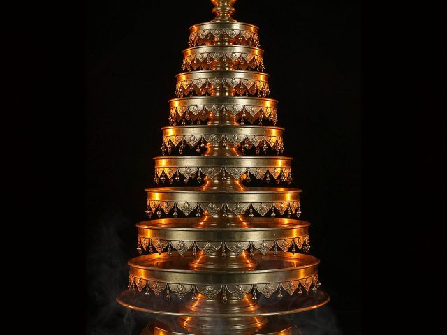 A nine-tiered polished brass blessing tower