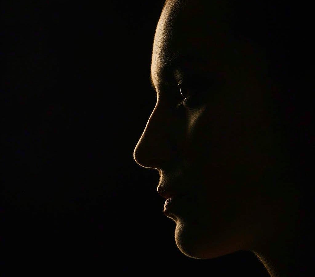 A side profile outlined in warm golden light