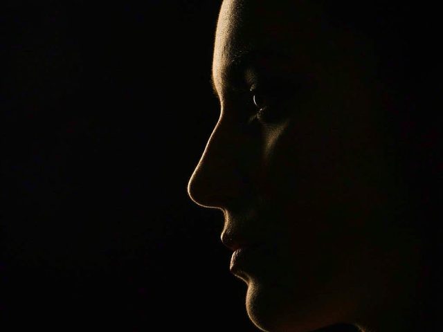 A side profile outlined in warm golden light